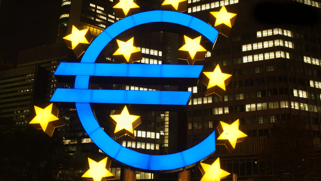 The distinctive modern exterior of the European Central Bank building in Frankfurt, featuring its tall tower and a prominent Euro currency logo, symbolizing the core function of a central bank in the eurozone.