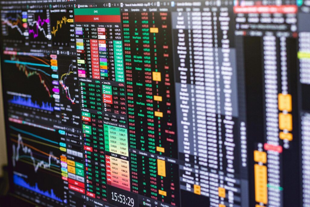 A close-up view of multiple colorful financial charts and graphs on a digital screen, representing various market indices and their performance trends.