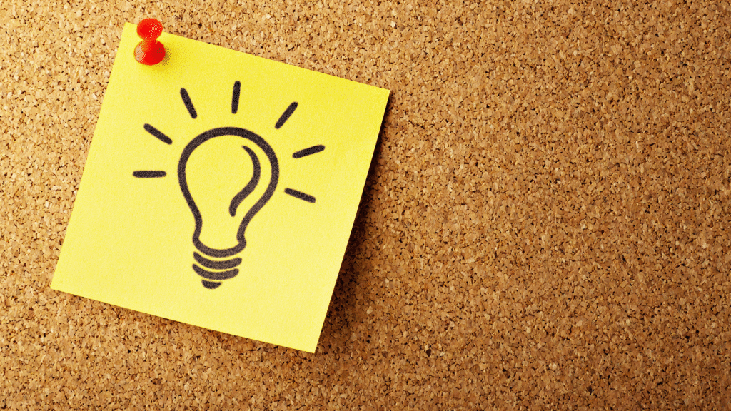 A yellow sticky note or paper affixed to a background, featuring a hand-drawn or stylized lightbulb, symbolizing the conceptualization and validation of a new business idea.