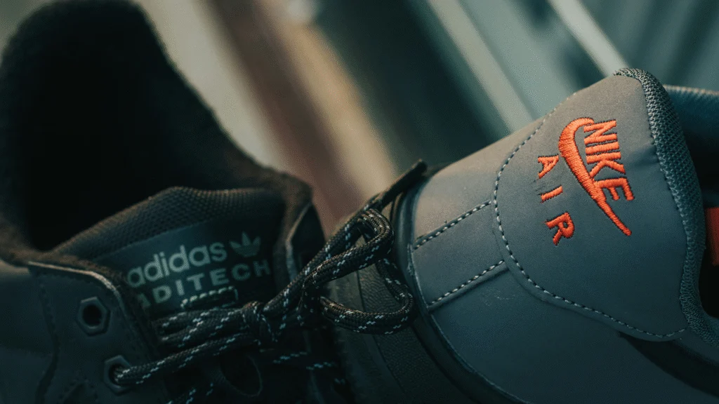 Side-by-side comparison of Nike and Adidas shoes, highlighting their distinct designs and brand logos.