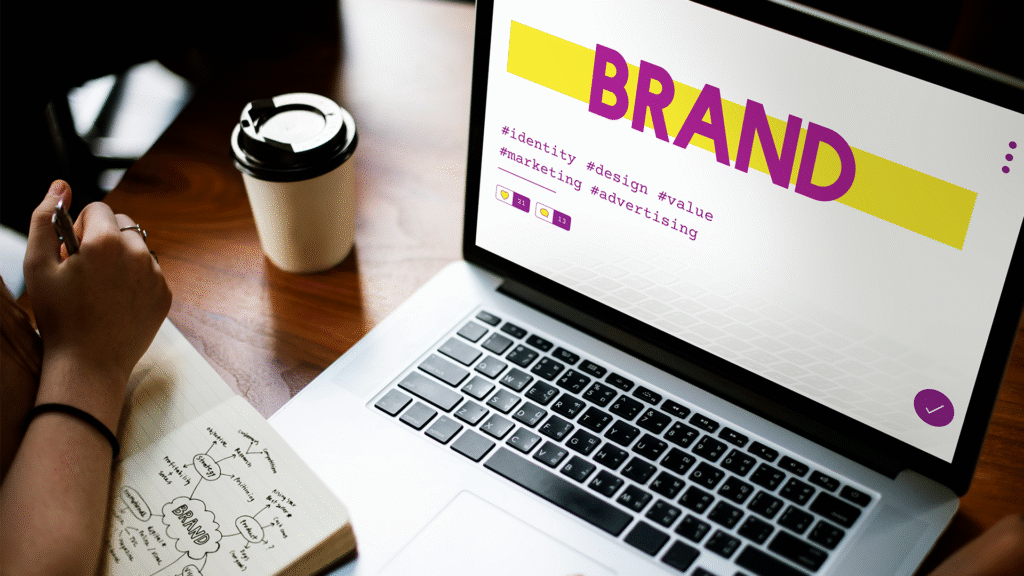 Laptop and digital icons representing online marketing and brand identity development.