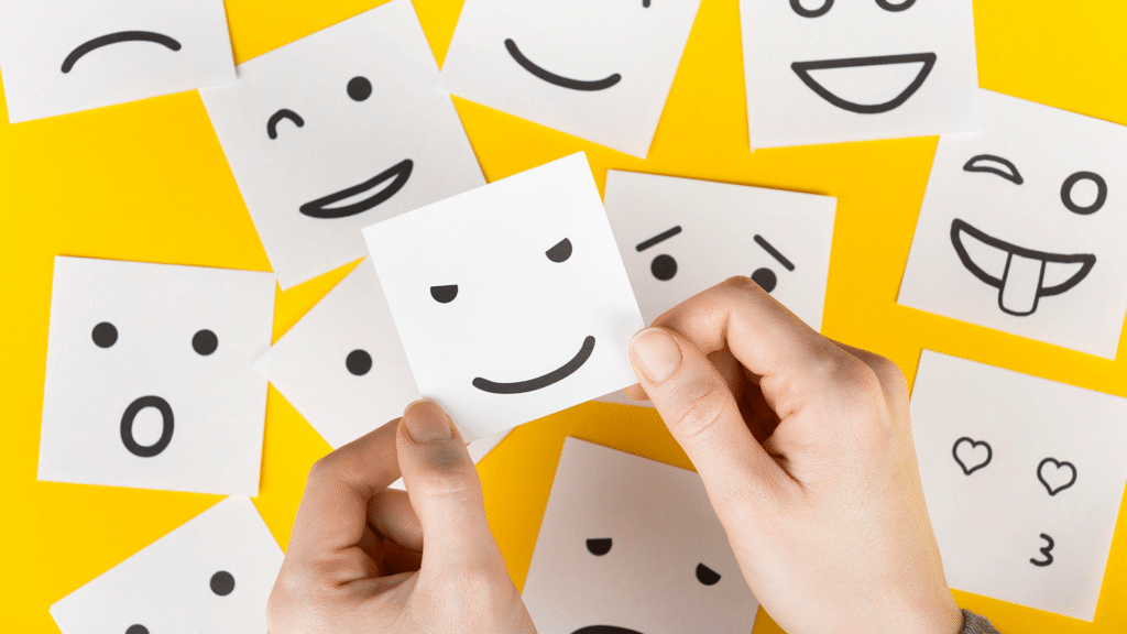 Flat lay of colorful emoji faces representing different emotions, symbolizing emotional marketing strategies.