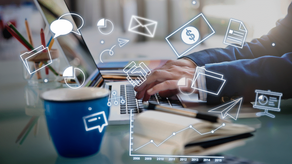 Close-up side view of a person’s hand typing on a laptop keyboard surrounded by digital marketing icons and elements representing online strategies.