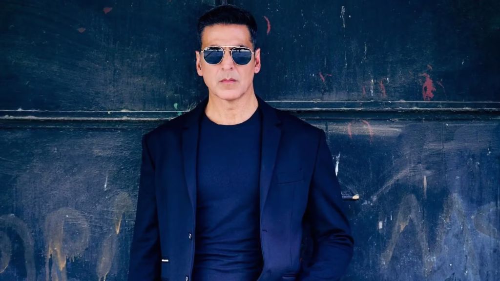 Akshay Kumar in blue suit and sunglasses representing his Cape of Good Films production house empire