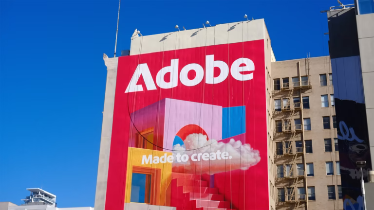 Adobe building billboard with Made to Create slogan showing Creative Cloud subscription model that tripled revenue from $4.2 billion to $21.5 billion by transforming from perpetual licenses to recurring subscriptions