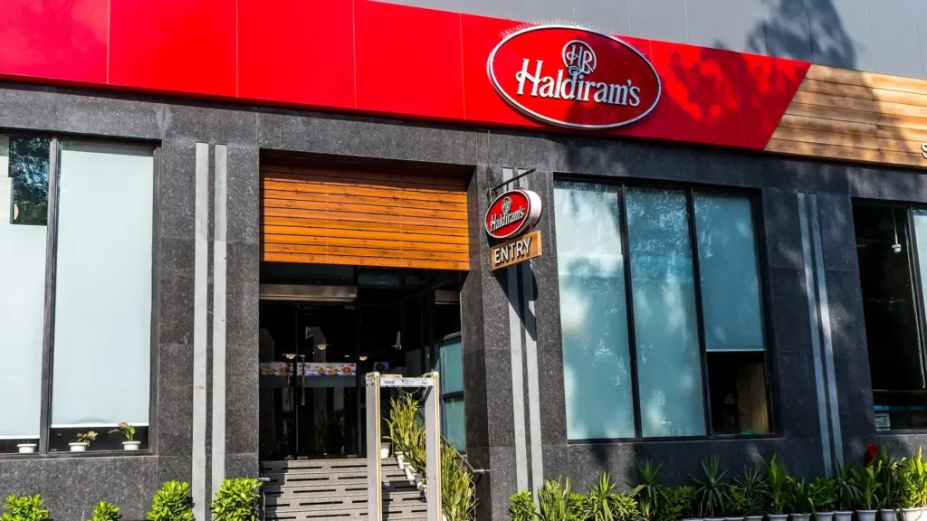 Haldiram's restaurant exterior with iconic red branding and signage, showcasing modern retail format and expansion strategy in Indian snack market