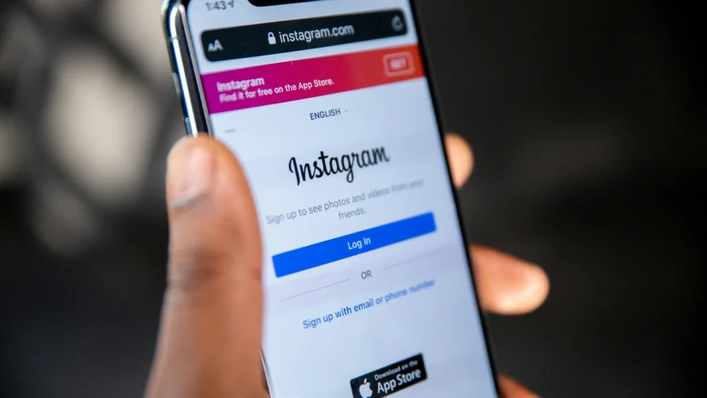 Instagram mobile app login screen displayed on iPhone showing distinctive logo and blue login button representing the photo-sharing platform that Facebook acquired for $1 billion in 2012