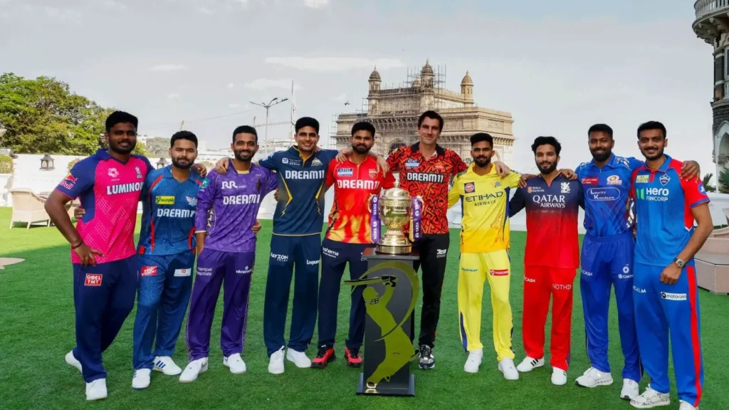 IPL team captains with trophy at Gateway of India representing IPL franchise costs reaching 7090 crore for Lucknow Super Giants and league total business value $18.5 billion in 2025