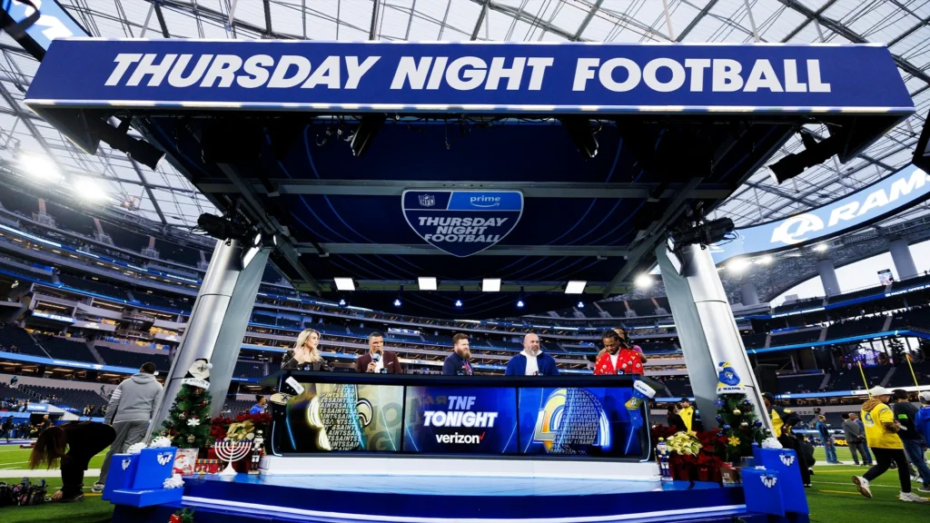 Amazon Prime Video Thursday Night Football broadcast set inside NFL stadium with commentators and TNF branding prominently displayed