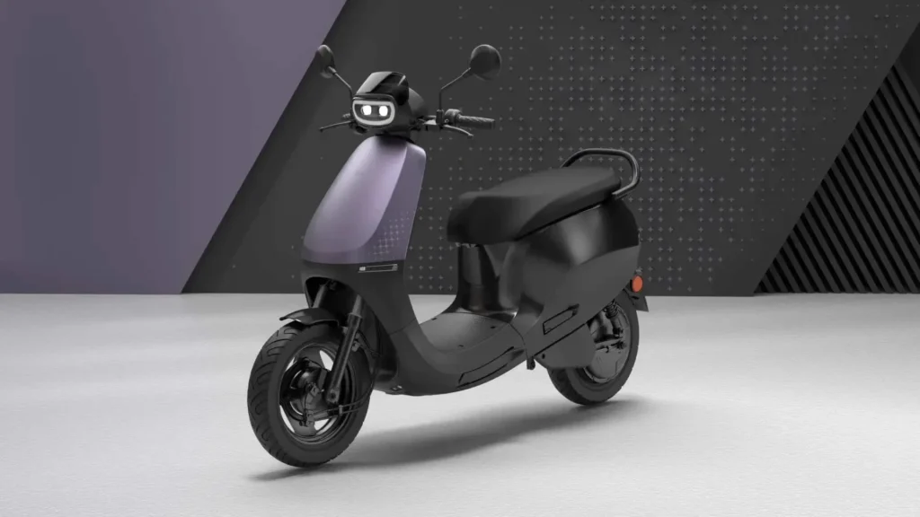 Ola S1 X electric scooter in matte black finish displayed in studio setting with purple gradient accent panel showing modern design of India's bestselling EV