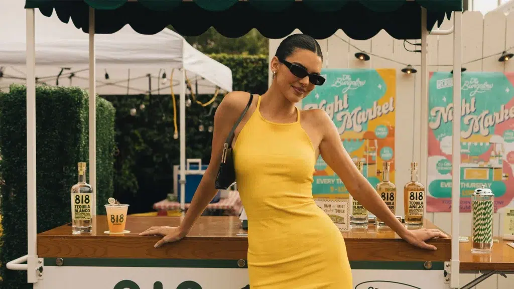 Kendall Jenner promoting 818 Tequila brand at promotional event with bottles displayed