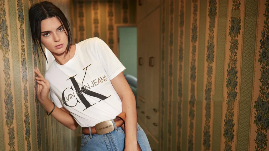 Kendall Jenner wearing white Calvin Klein Jeans t-shirt and denim shorts with CK belt in casual campaign photoshoot