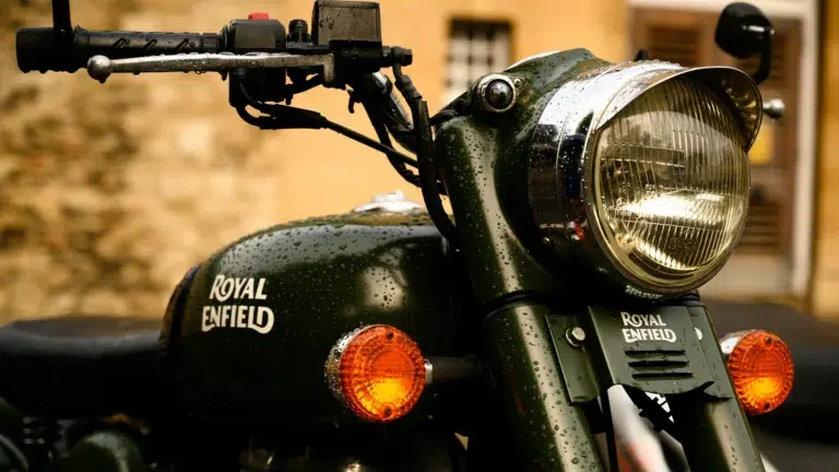 Royal Enfield motorcycle front view in dark green with chrome headlight and amber indicators showing the iconic heritage design that defines Royal Enfield lifestyle motorcycling brand identity
