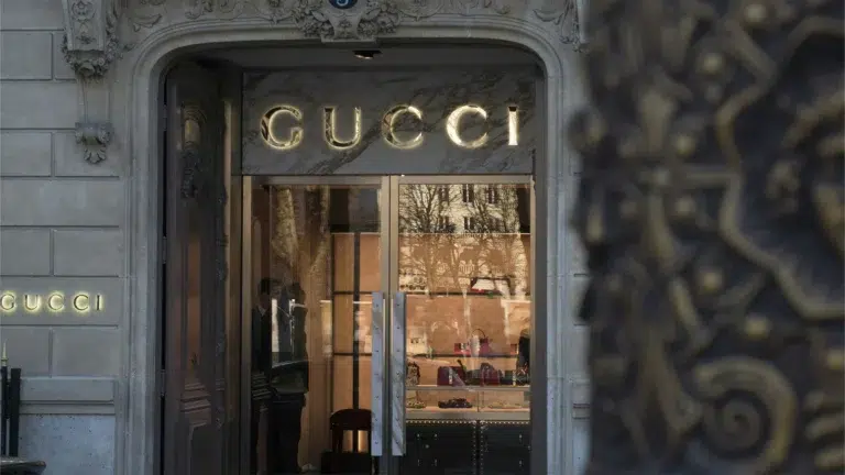 Gucci store entrance with illuminated gold signage reflecting the brand's luxury heritage and strategic reinvention