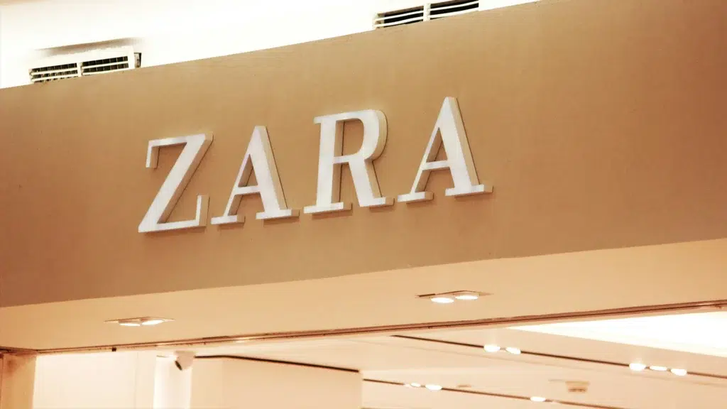 Zara store signage with white letters on beige wall in retail interior