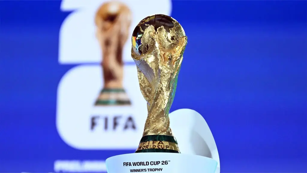FIFA World Cup 26 winner trophy on display FIFA branding blue background North America 2026 host nations economics