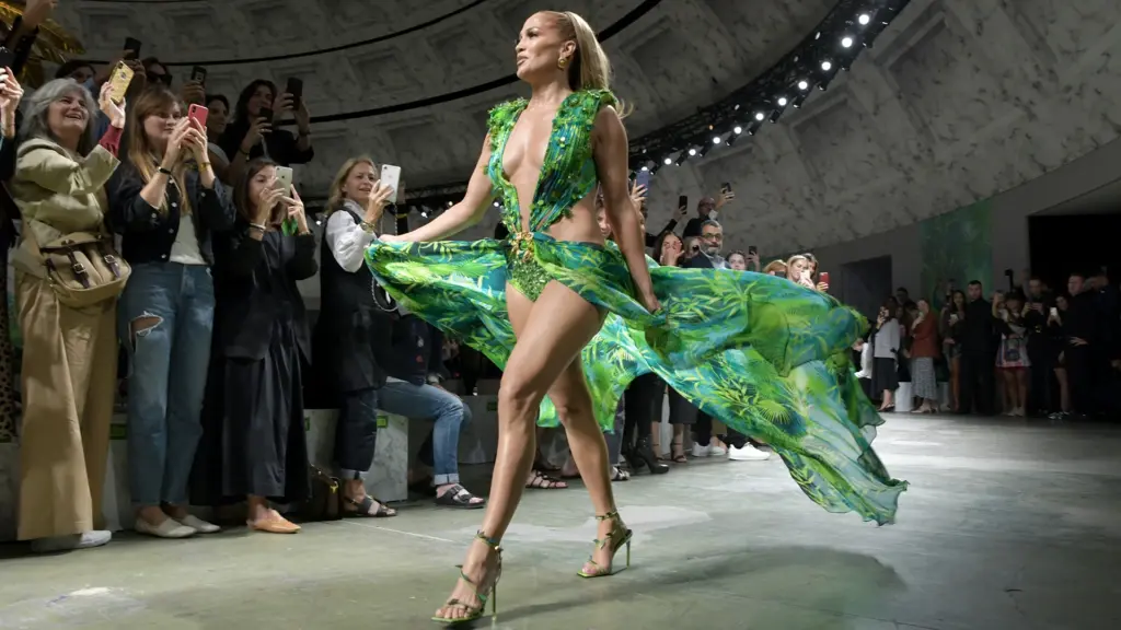 Jennifer Lopez walking the Versace Spring Summer 2020 Milan Fashion Week runway in reimagined green jungle print plunging dress to standing ovation from the audience