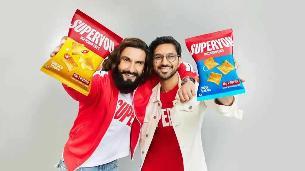 Ranveer Singh and SuperYou co-founder Nikunj Biyani holding SuperYou Multigrain Protein Chips at a brand promotional shoot in Mumbai