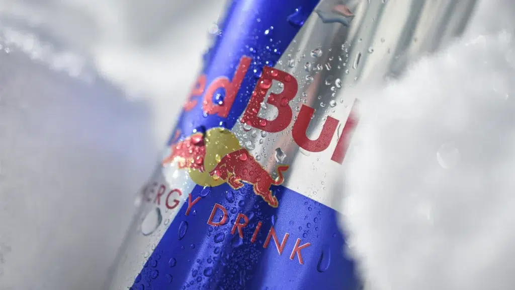 Red Bull energy drink can covered in ice droplets close up showing branding and logo