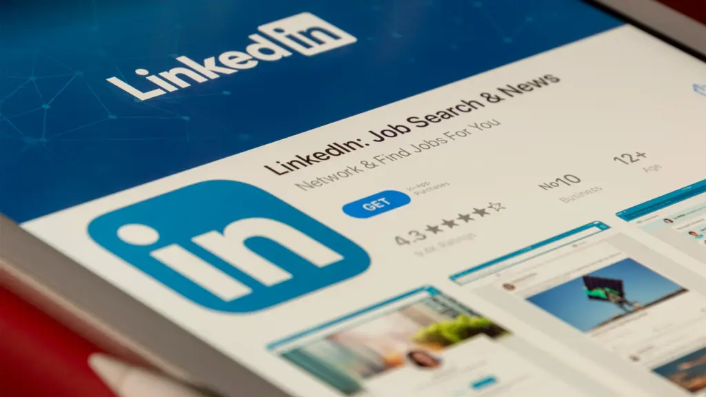 LinkedIn app on tablet screen showing job search and professional network features representing the world's largest professional social platform
