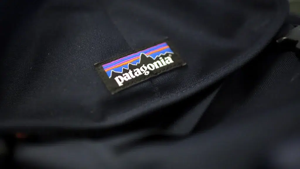 Close-up of Patagonia logo patch on dark navy jacket fabric showing brand identity and outdoor apparel quality