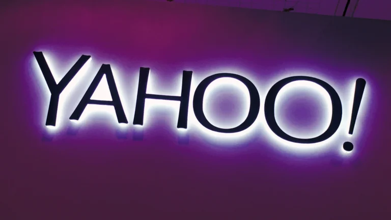 Yahoo logo illuminated in purple representing the internet company's rise and fall after rejecting Google and Microsoft acquisition offers